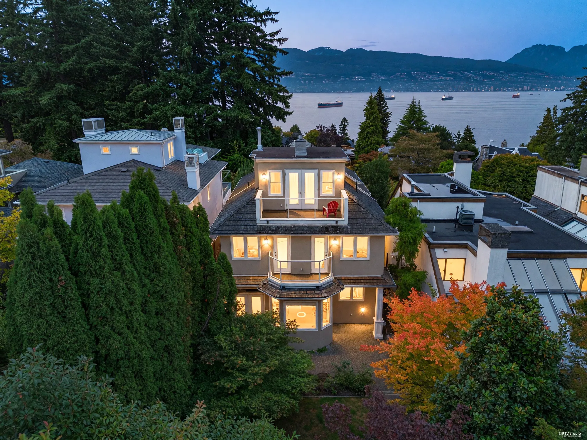 The house from the air at dusk with the water beyond