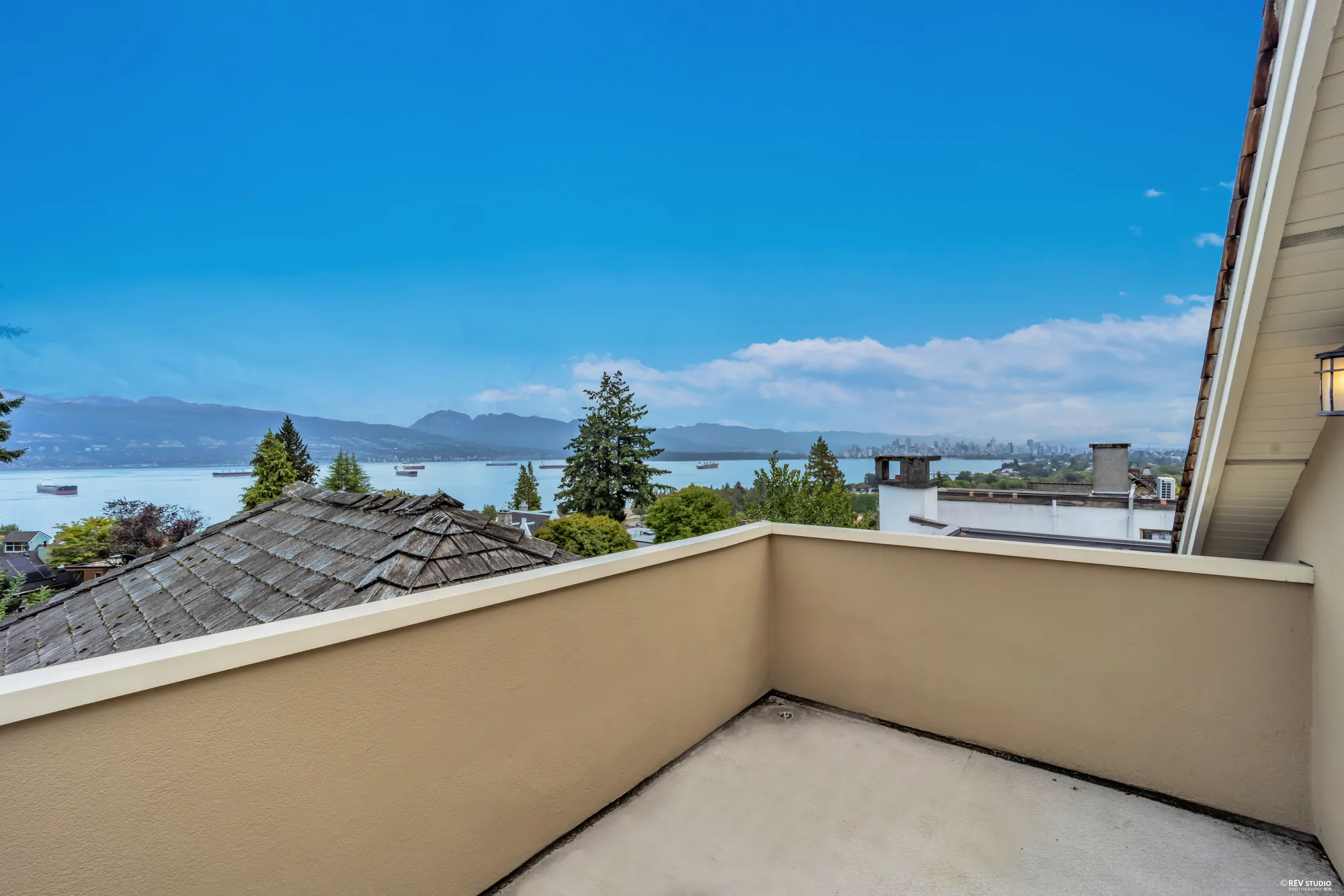 The upper roof deck with a parapet and the water beyond