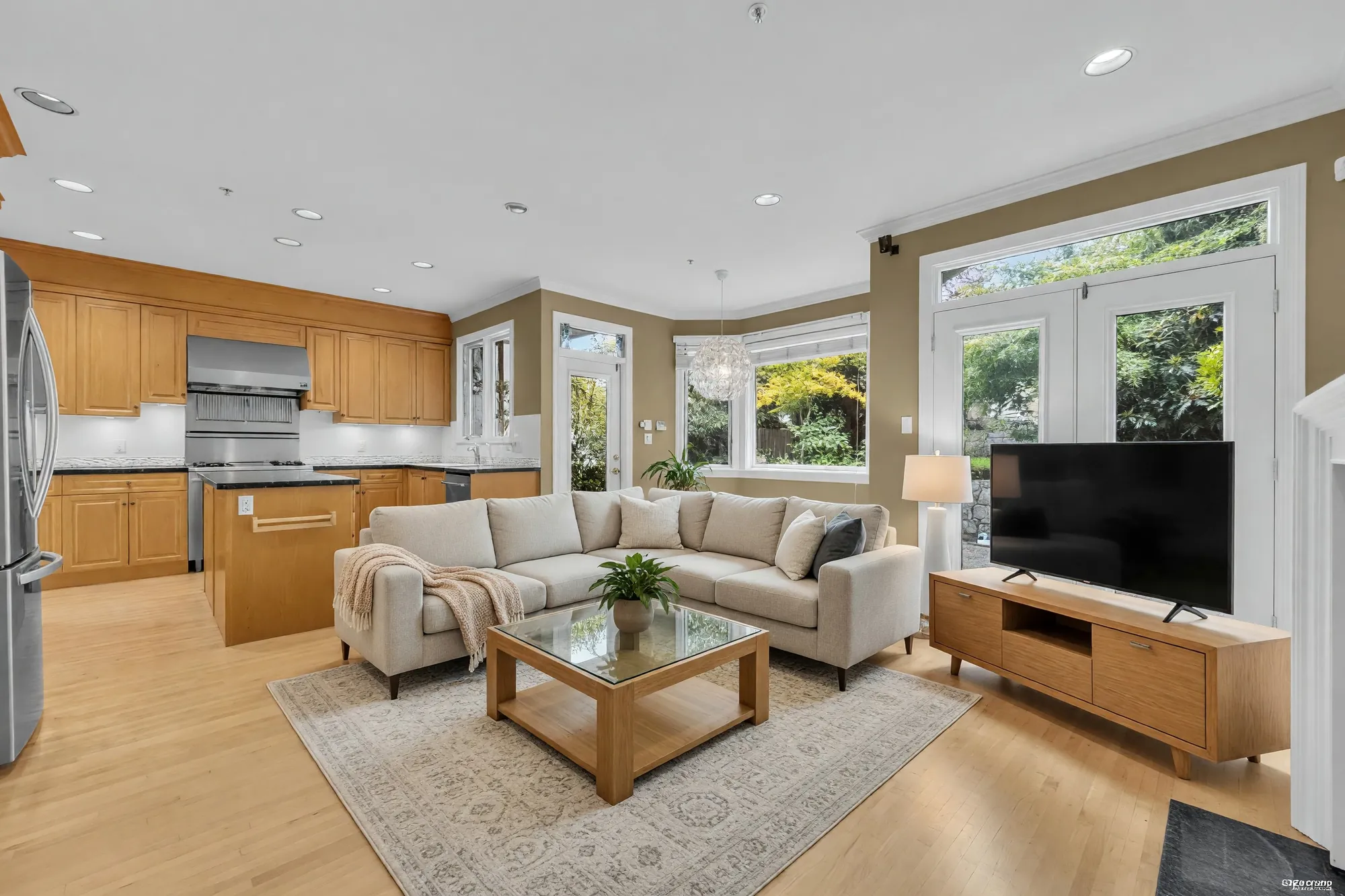 The family room beside the kitchen, shown with digitally added seating