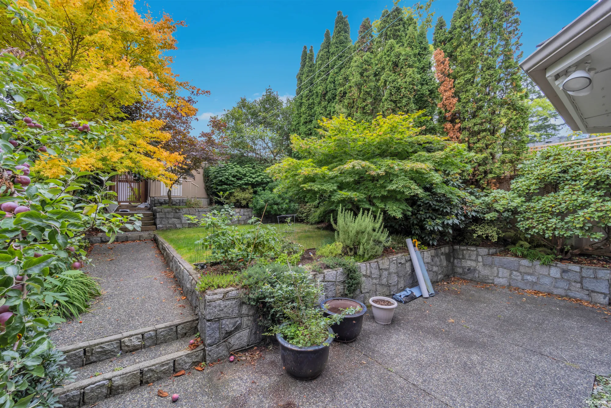 A terraced planting bed with a stone retaining wall