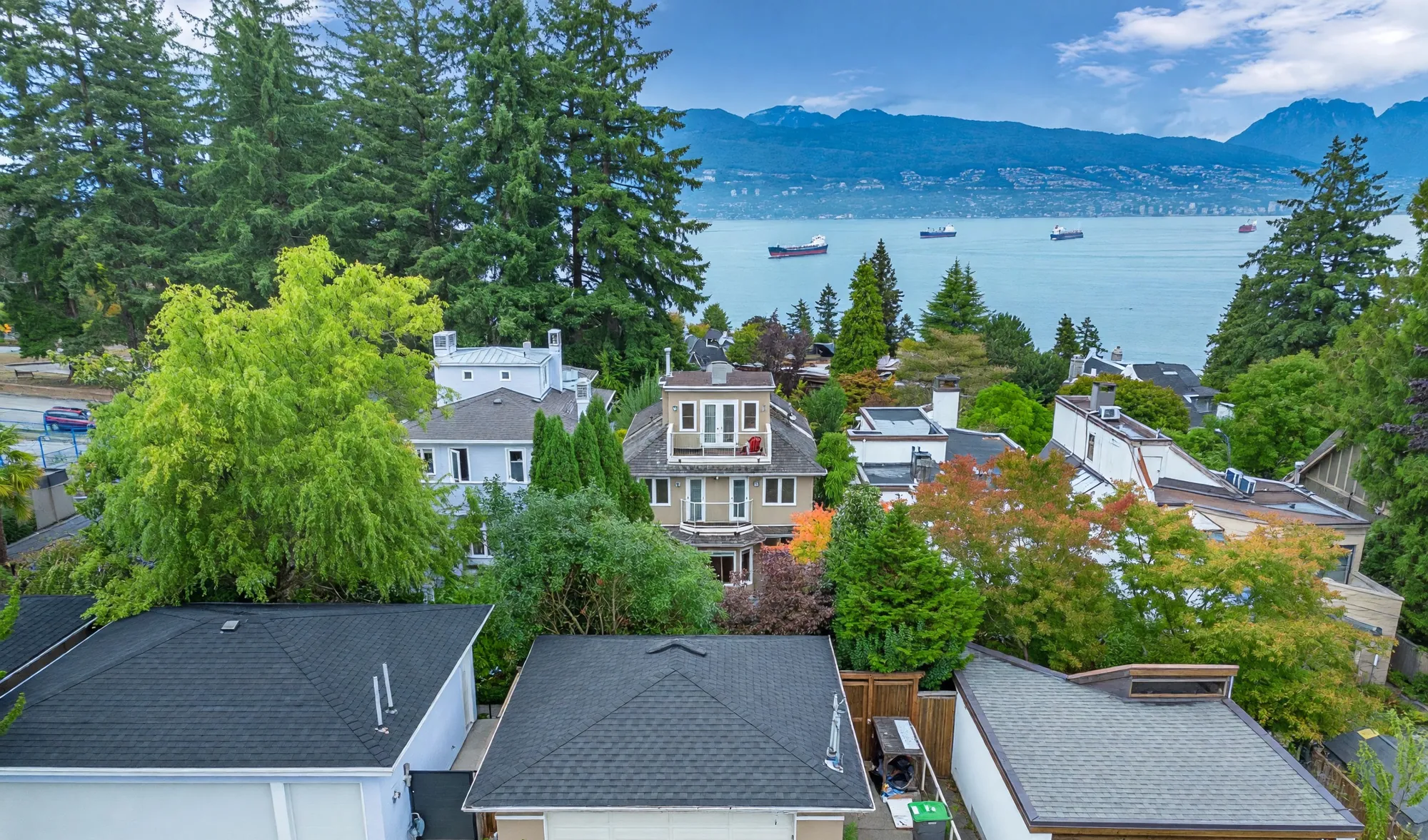 4648 West 2nd Avenue from the air, looking north over the rooftops to English Bay and the North Shore mountains