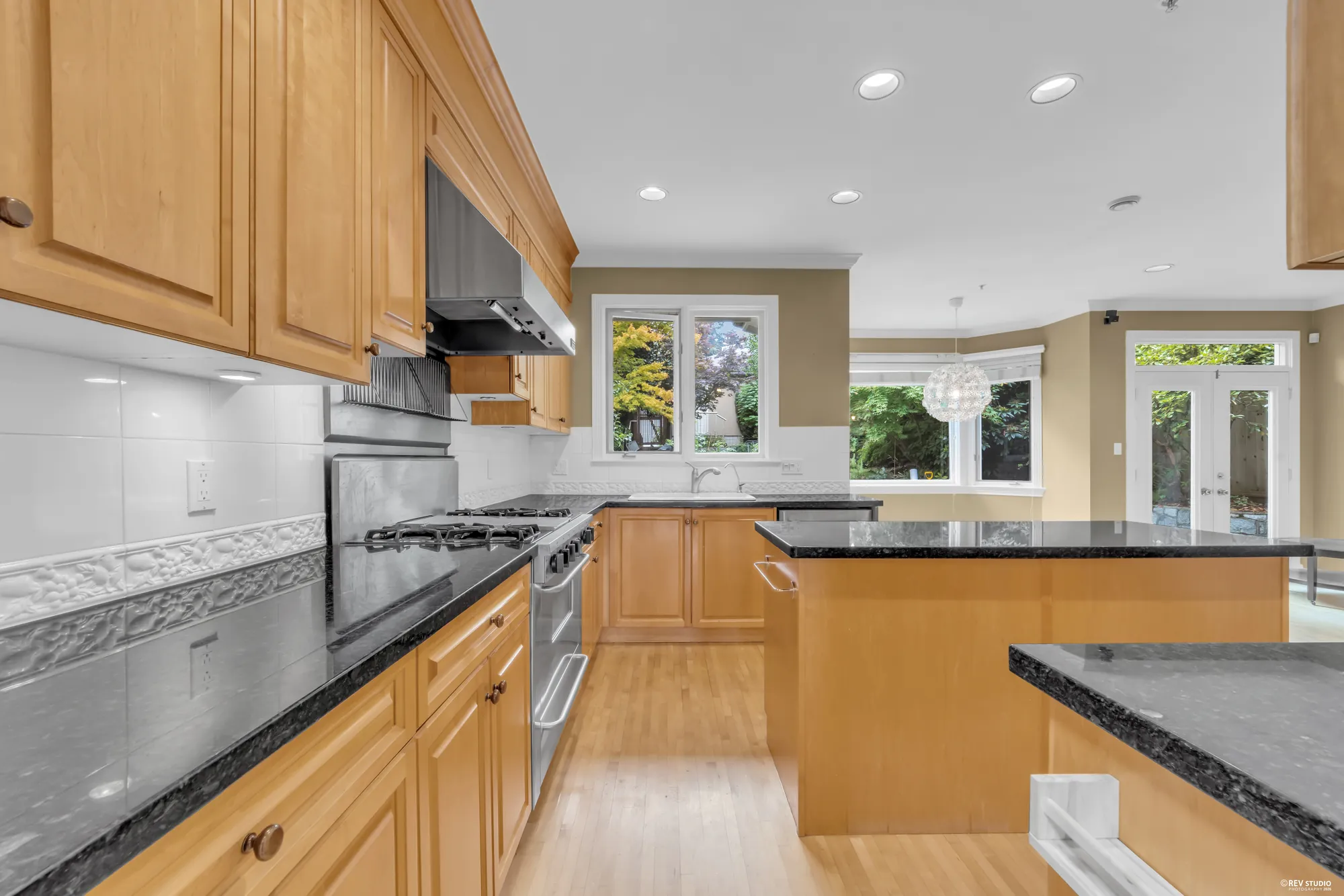The cooktop and hood with a window above the counter