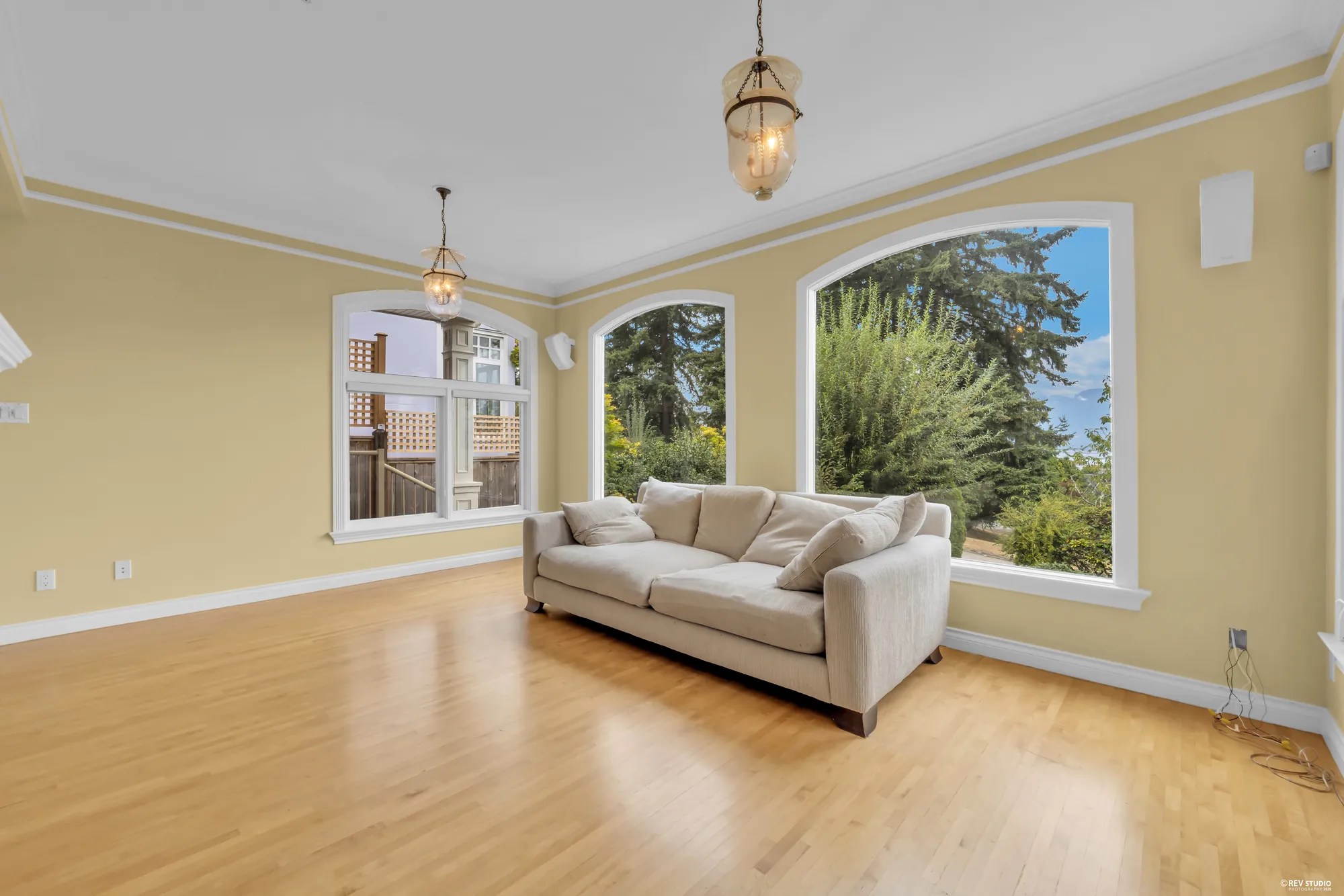 The living room looking toward the windows and a sofa
