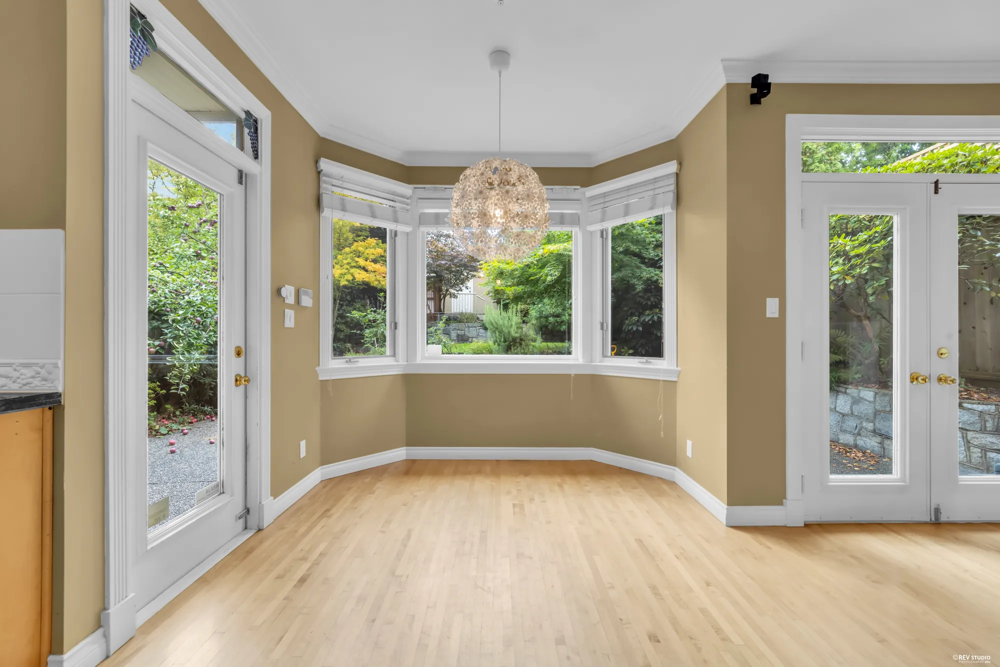 The breakfast nook in a bay window with a door to the patio