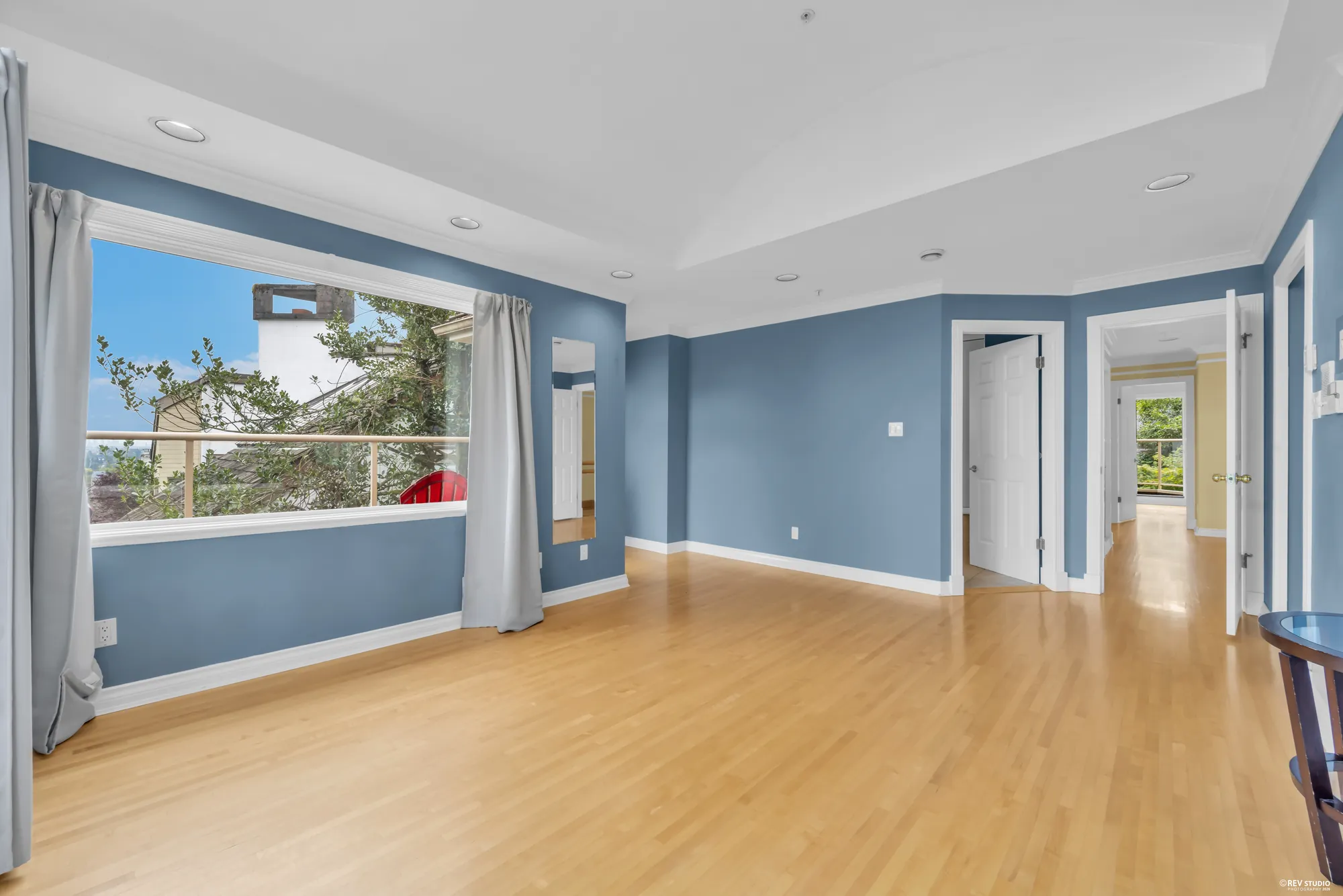 The primary bedroom from the other corner with a doorway to the walk-in closet