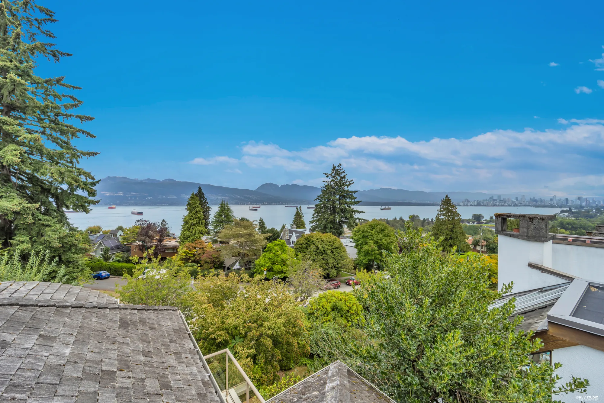 English Bay seen over the neighbouring rooftops and trees