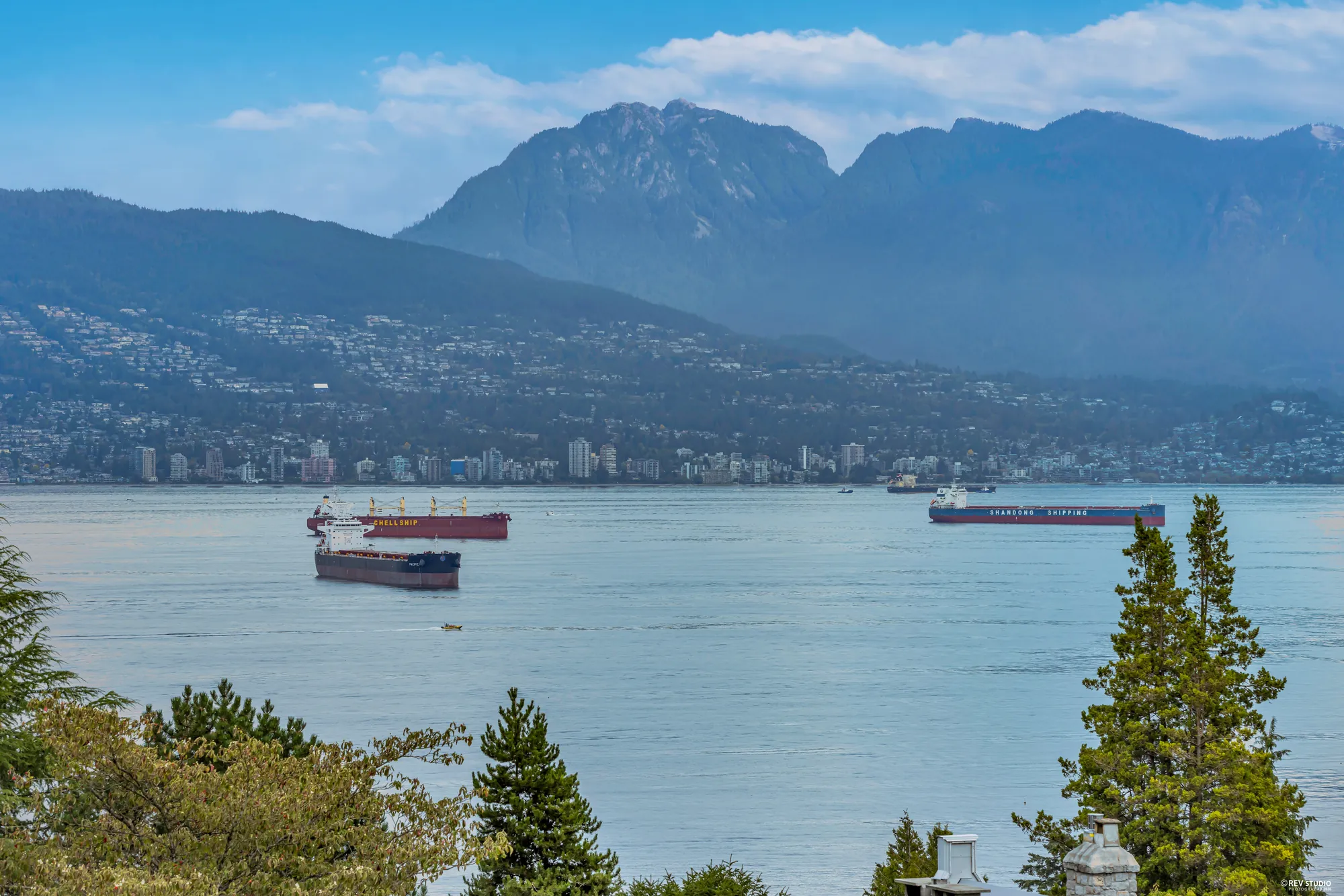 The North Shore mountains and freighters at anchor in English Bay
