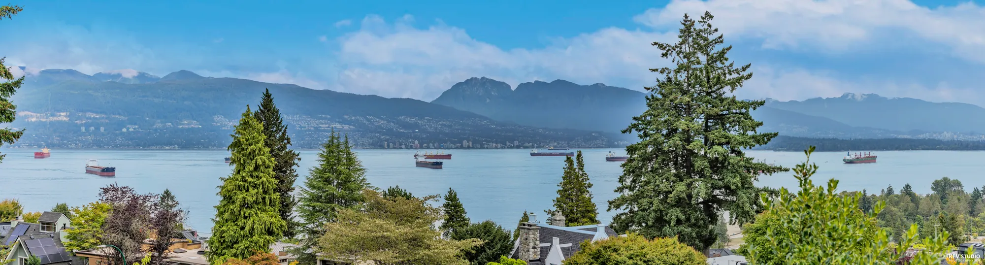 A wide panorama north from the property across English Bay to the North Shore mountains